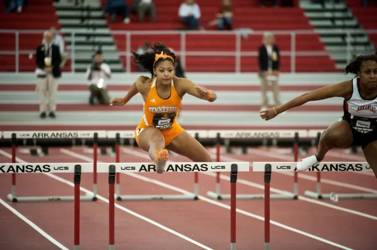 Bianca Belair jumping a hurdle for the University of Tennessee